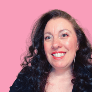 Karen Preene smiling to the side of the camera, against a pink background