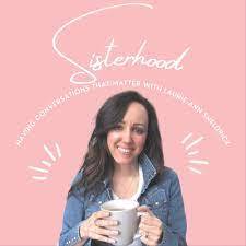 Pink background, the word sisterhood and Laurie-ann Sheldrick holding a mug and smiling into the camera